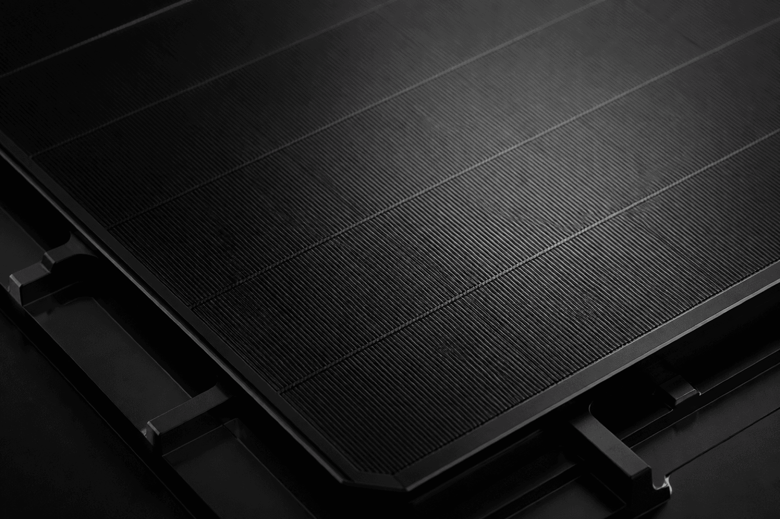 Macro detail of a busbar-free matte-black HPBC 2.0 solar cell surface